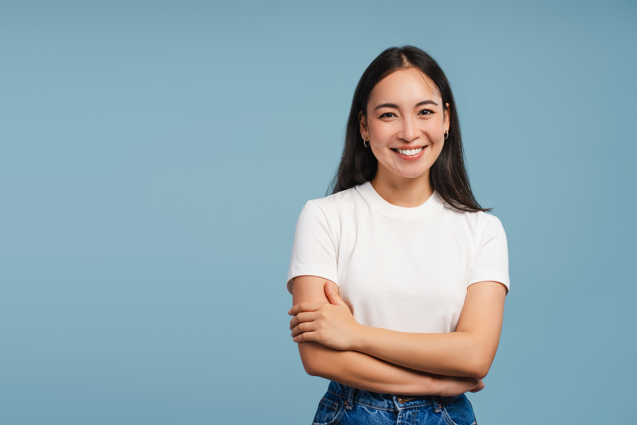 Woman smiling in front of blue background