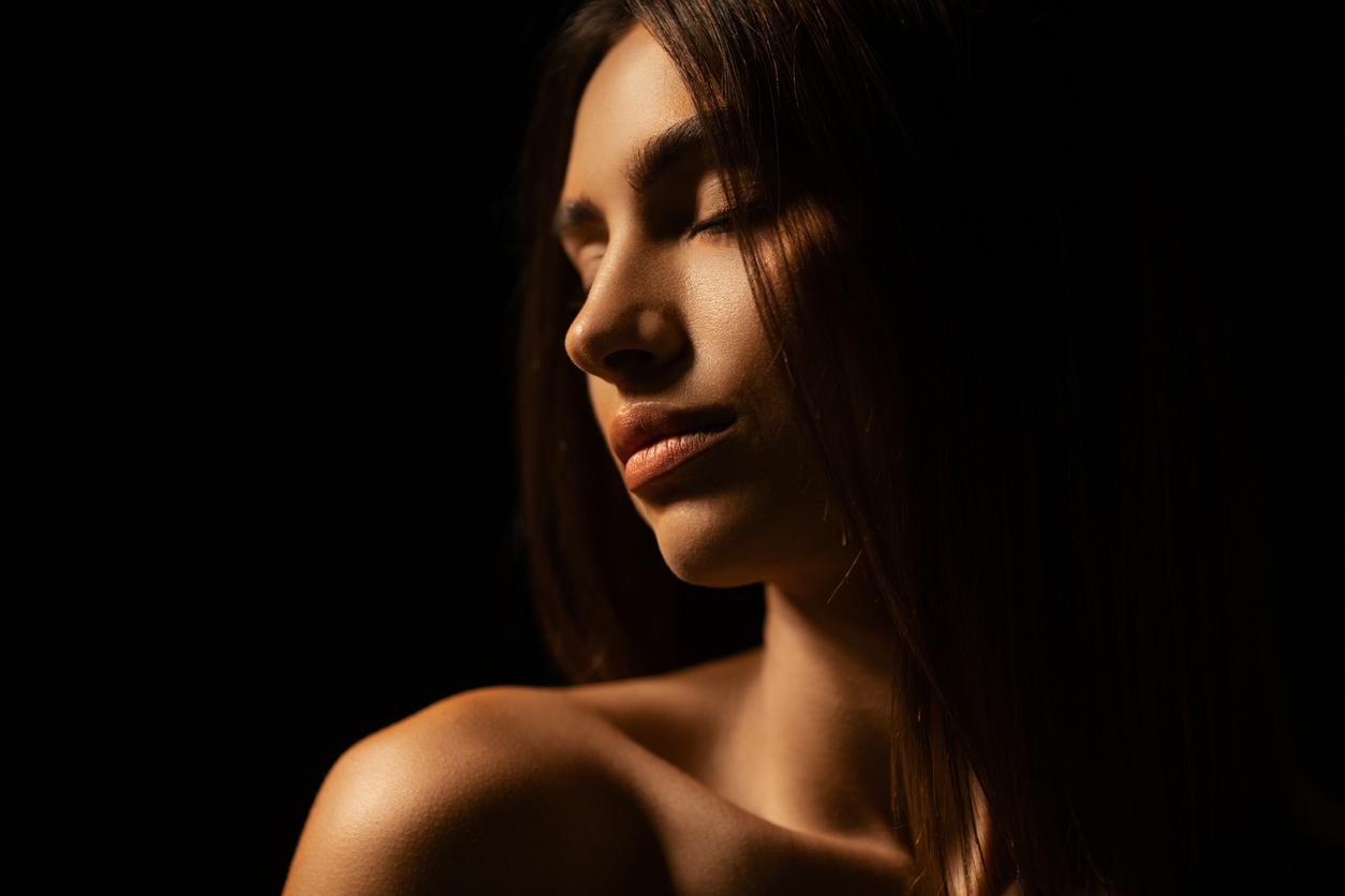 Woman in side profile with defined nose and facial contours