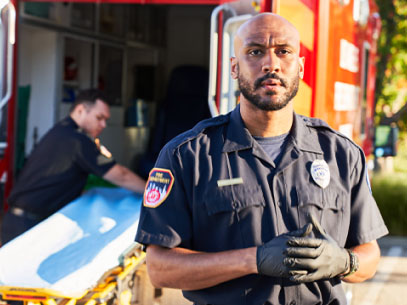 EMT standing in front of an ambulance.