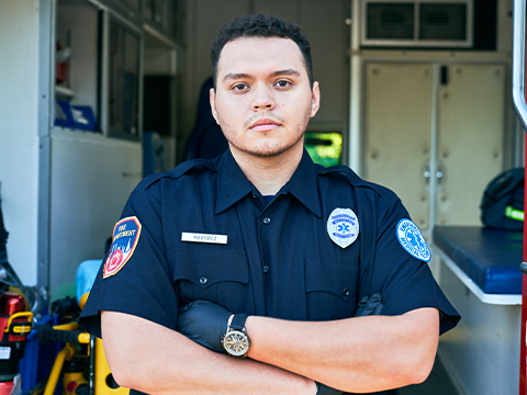 EMT standing in front of an ambulance.