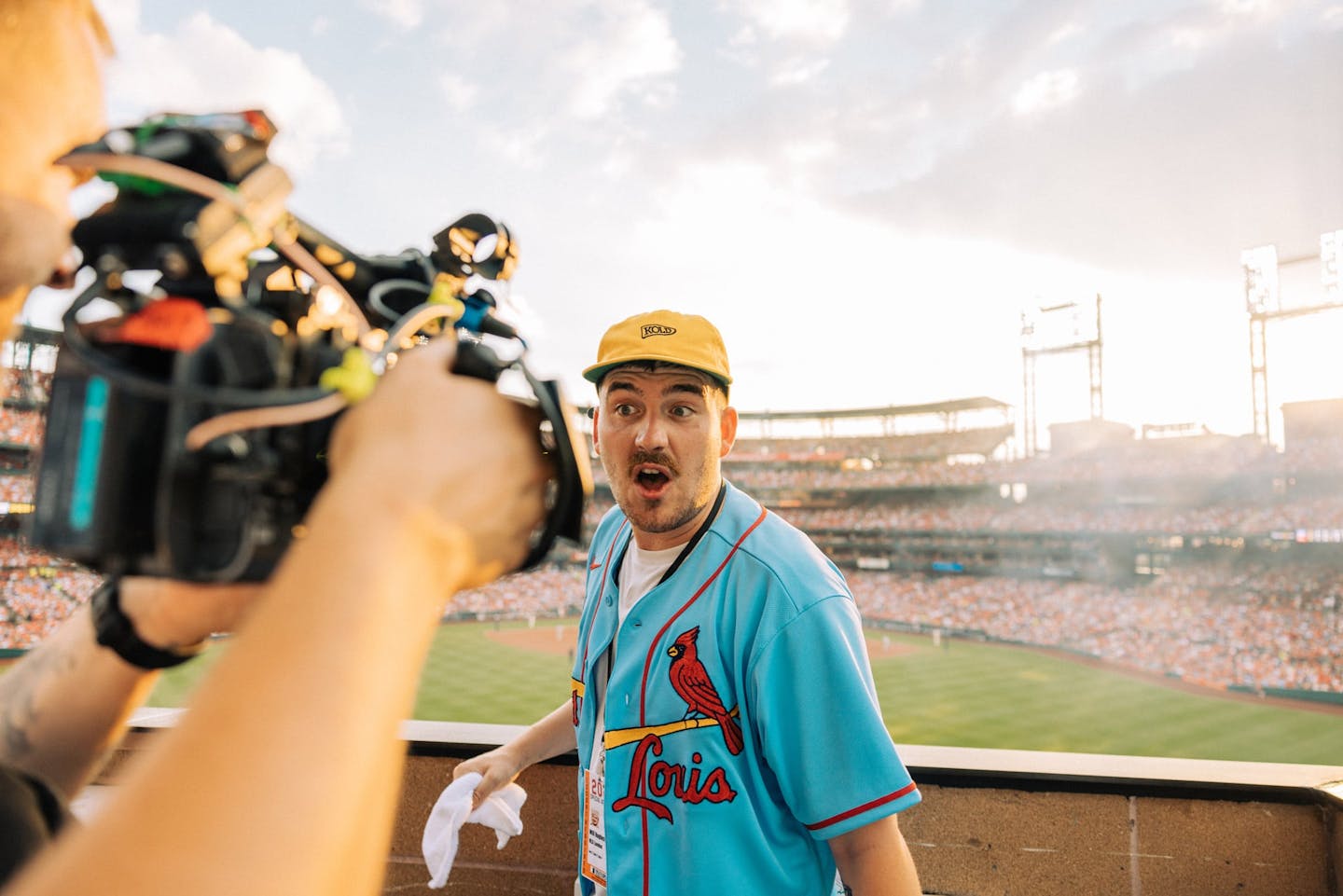 Man in a baseball ground being filmed