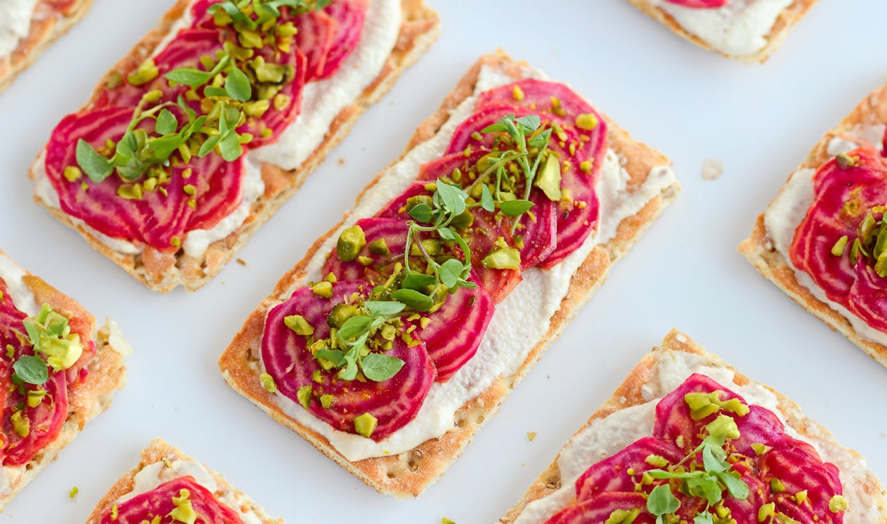 Crispbreads with vegetables on top decoratively positioned