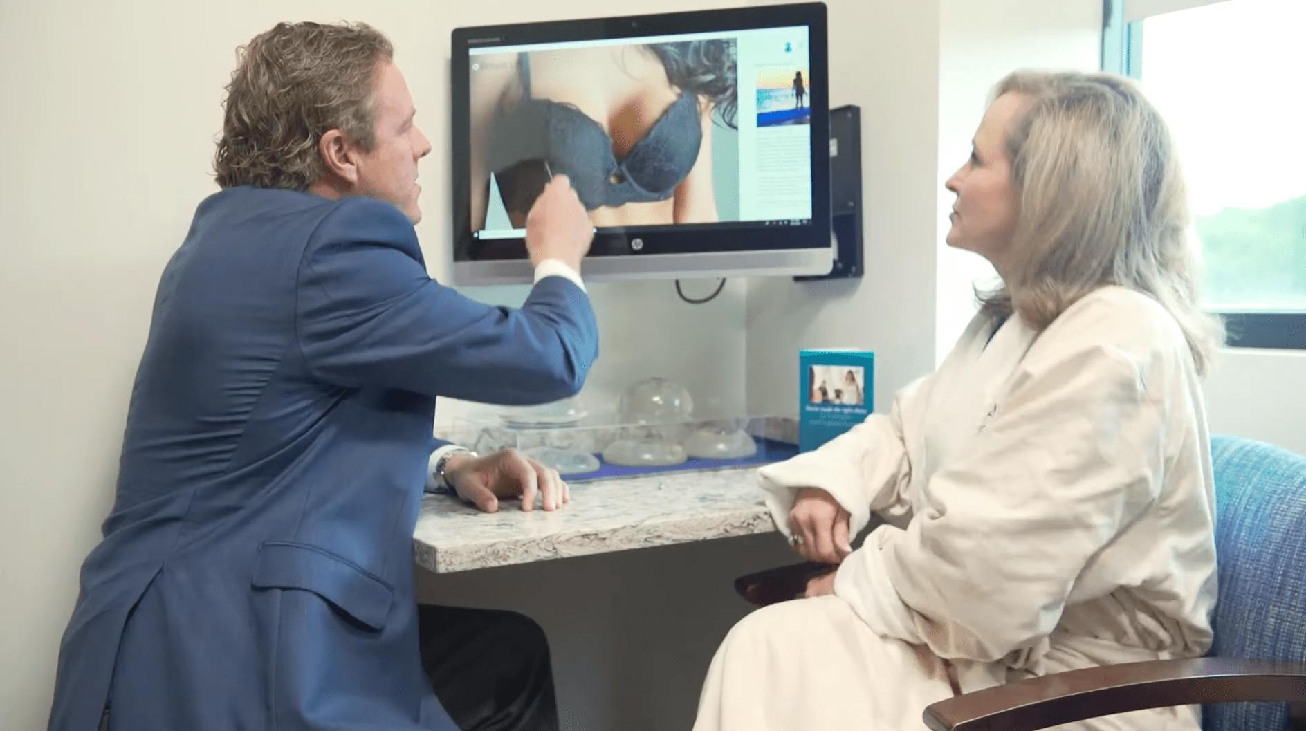 Dr. Haydon duscussing an image on a computer screen with a patient