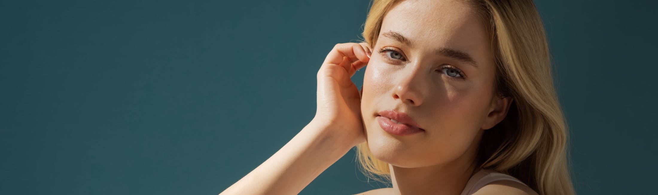 Woman with blonde hair with the sunlight shining on her face