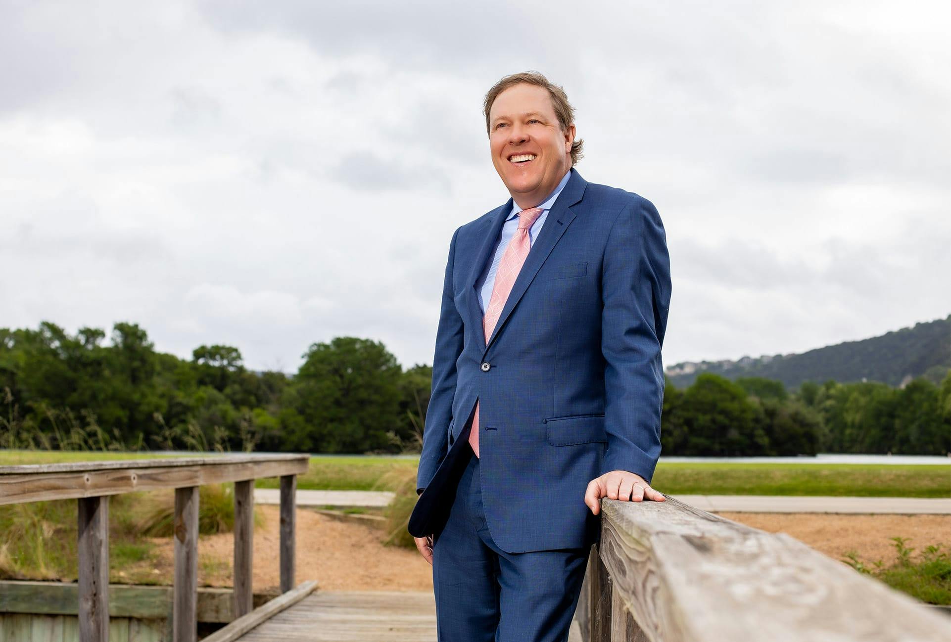 Dr. Haydon in a suit on a bridge