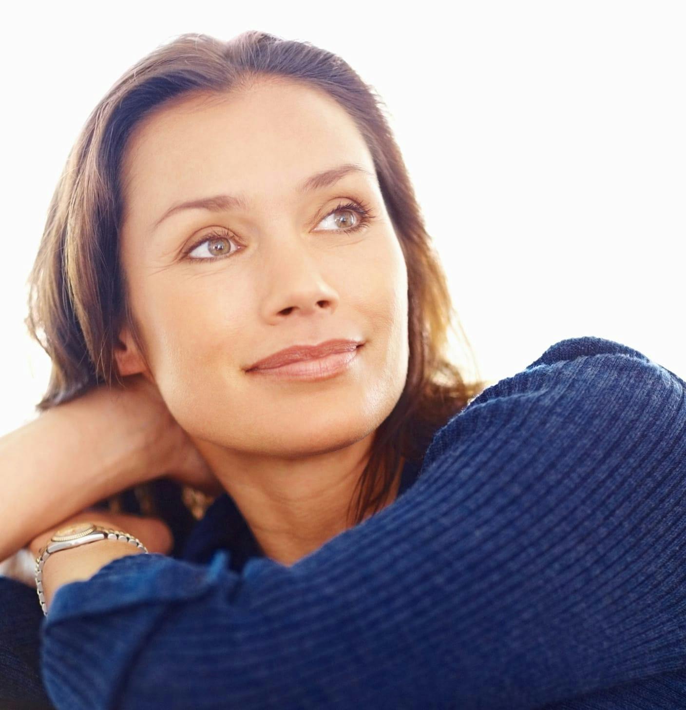Woman in sweater looking over her shoulder