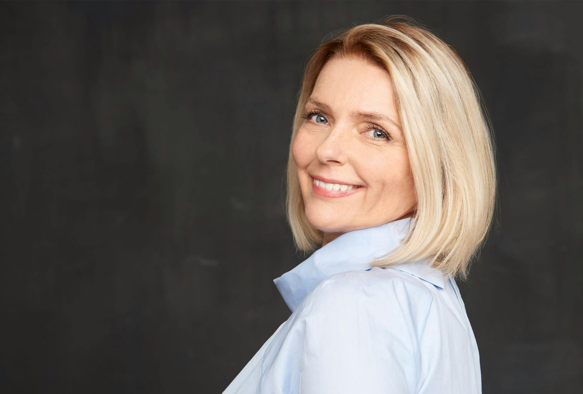 Woman looking over her shoulder, smiling