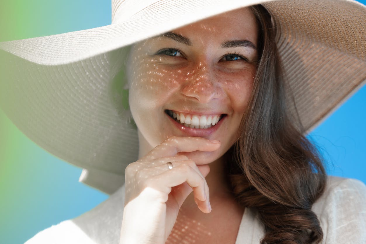 Woman smiling while touching chin