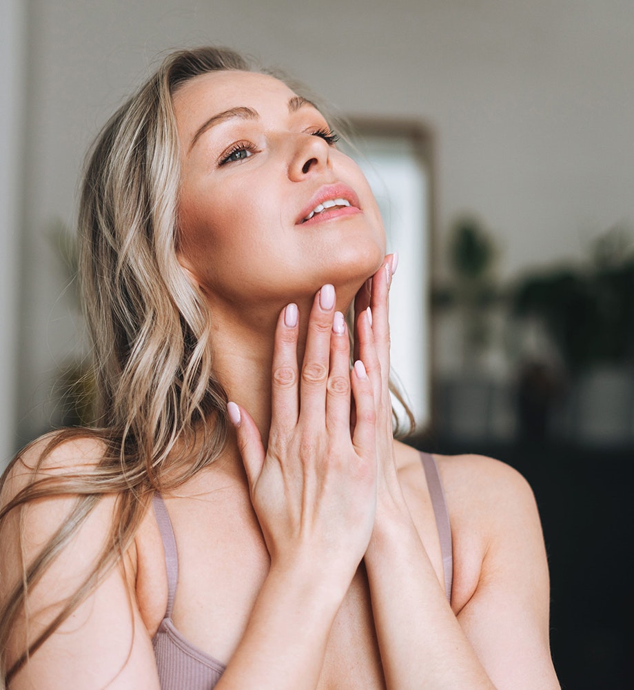 woman touching her neck area
