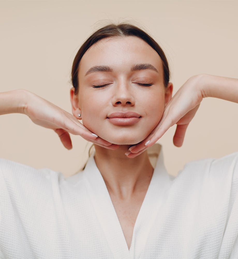 woman with her eyes closed and her hands under her face