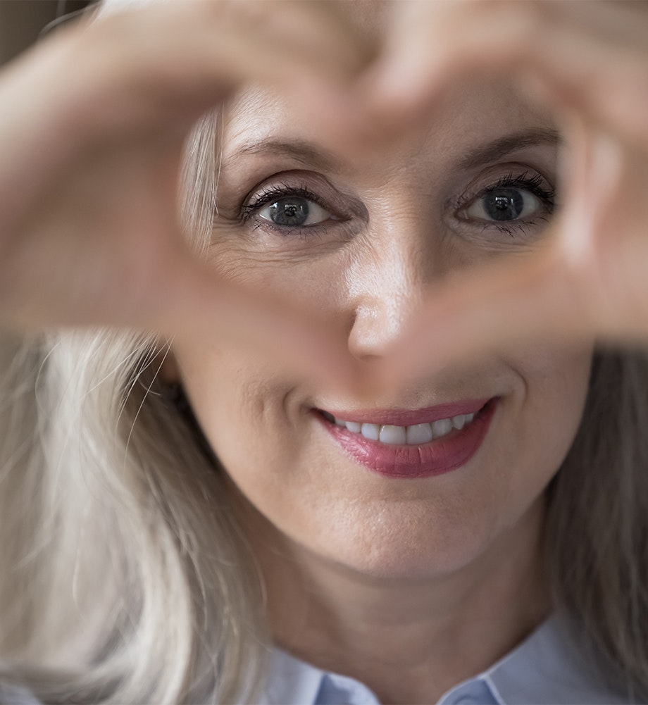 Microneedling female patient making a heart shape with her hands