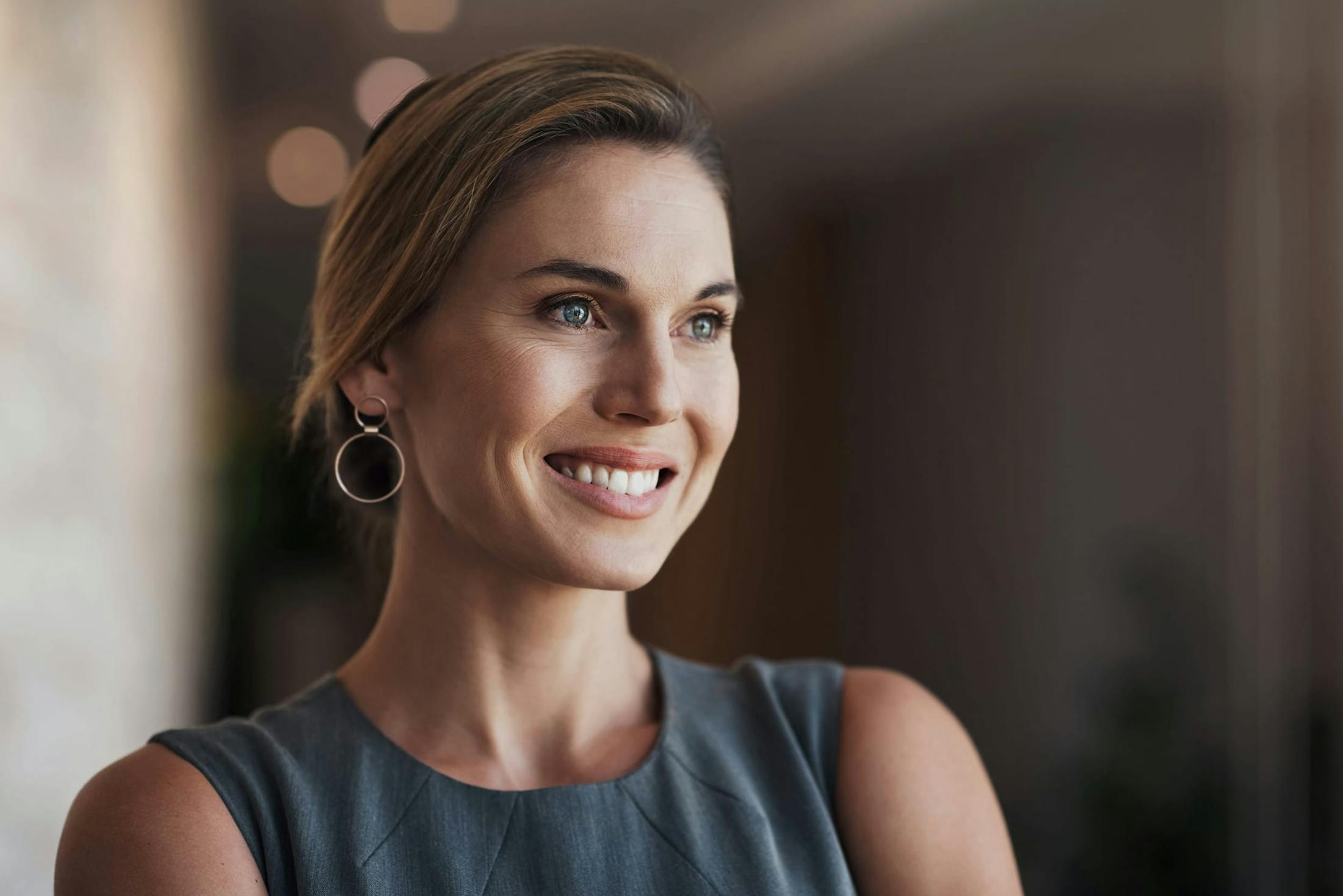 Woman smiling with a grey shirt on