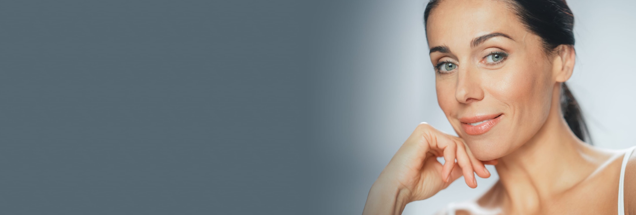 woman touching her lower face