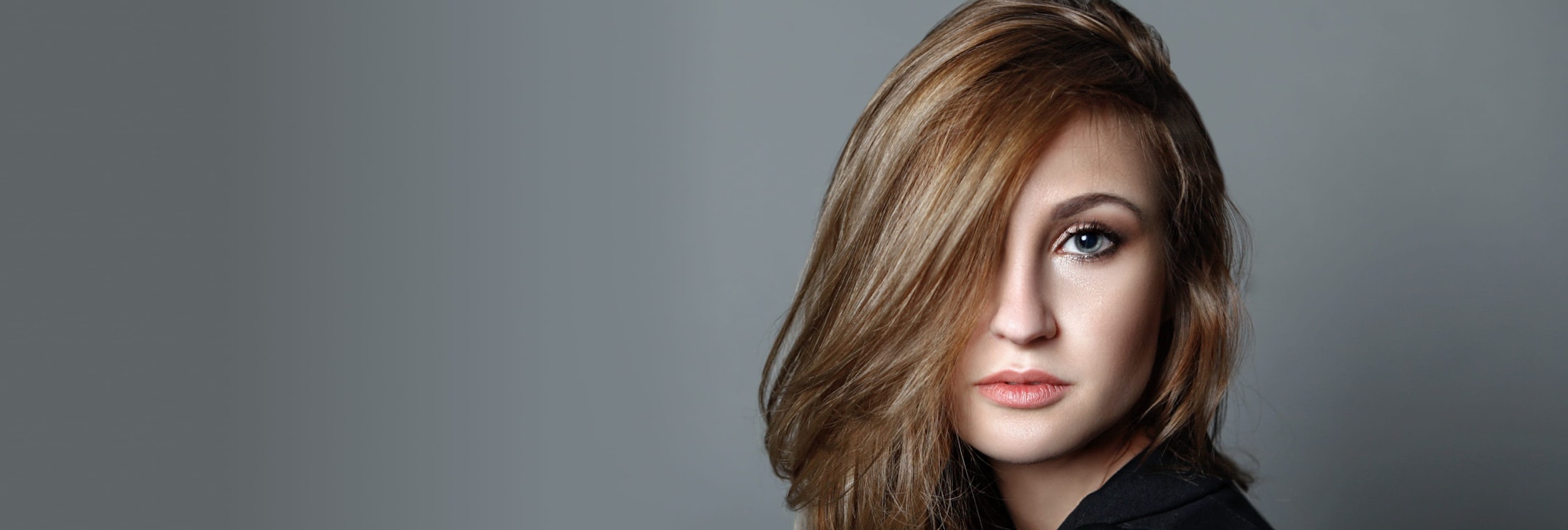 woman with blonde hair in her face