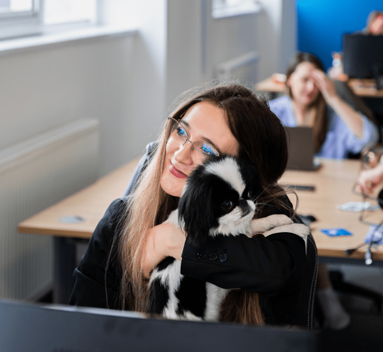 Shot of a MarCloud team member and the office dog