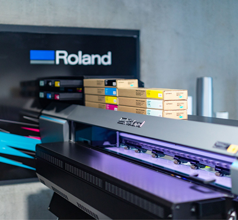 Roland DG printer with logo in background