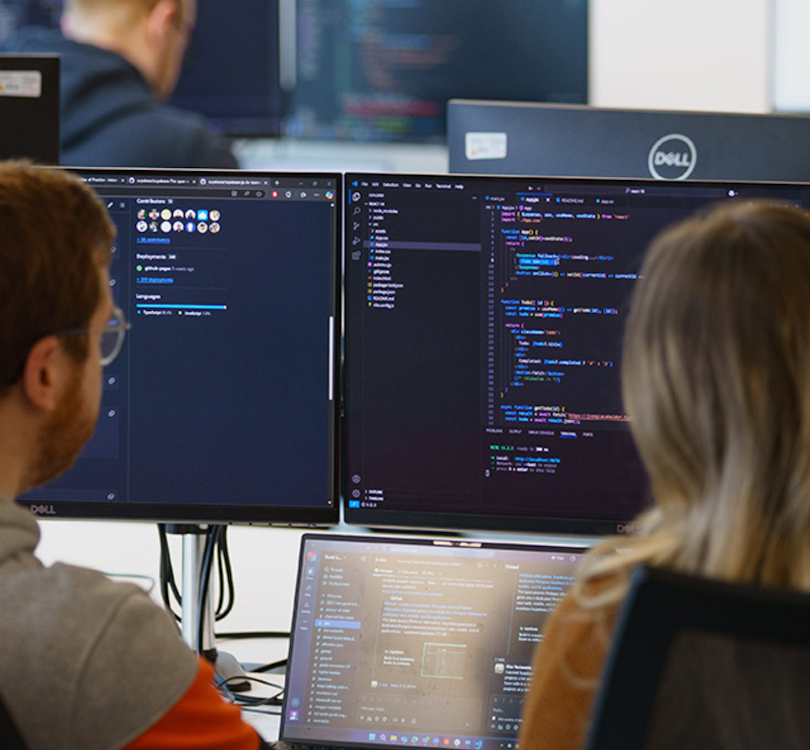 Photograph of Scott Logic team coding on computer