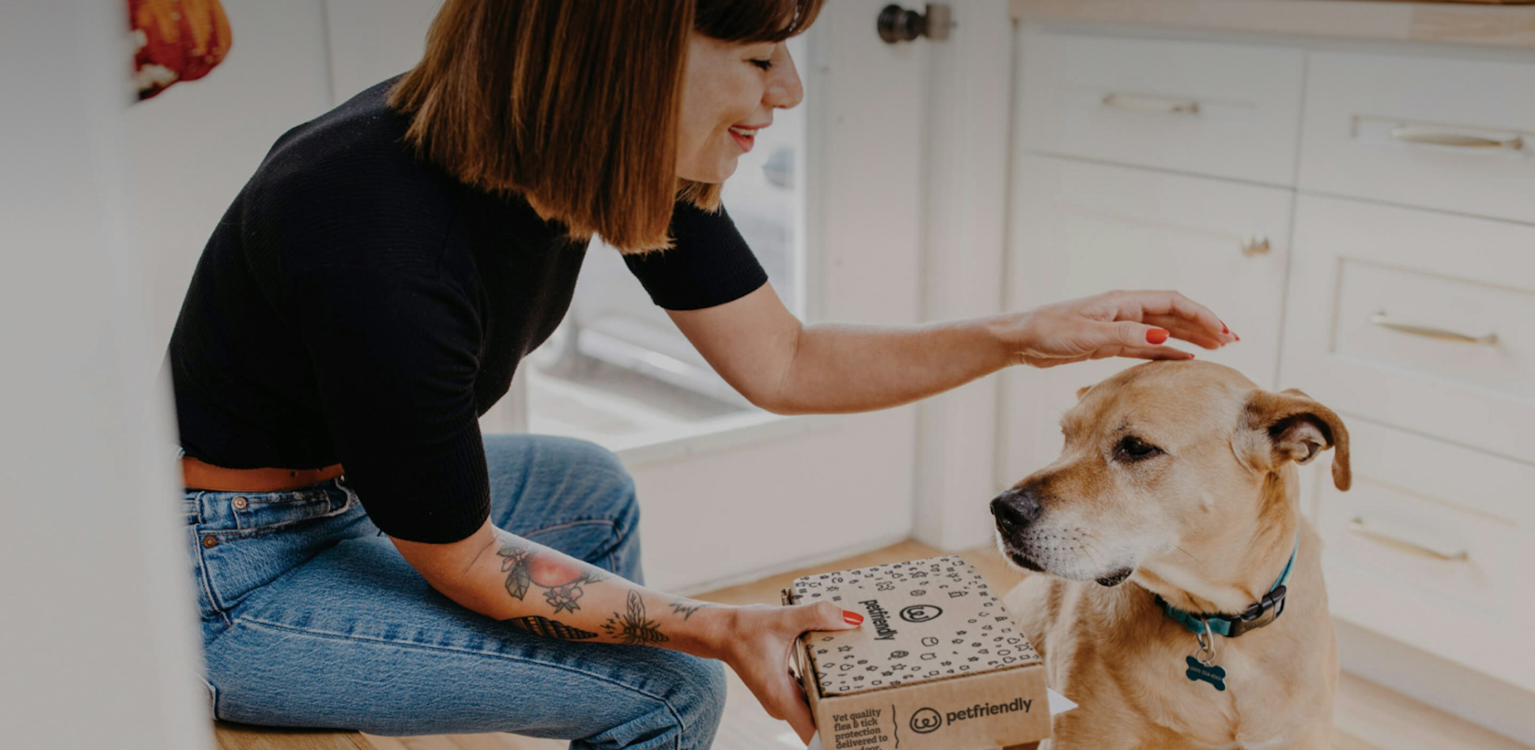 Women giving a PetFriendly box to dog
