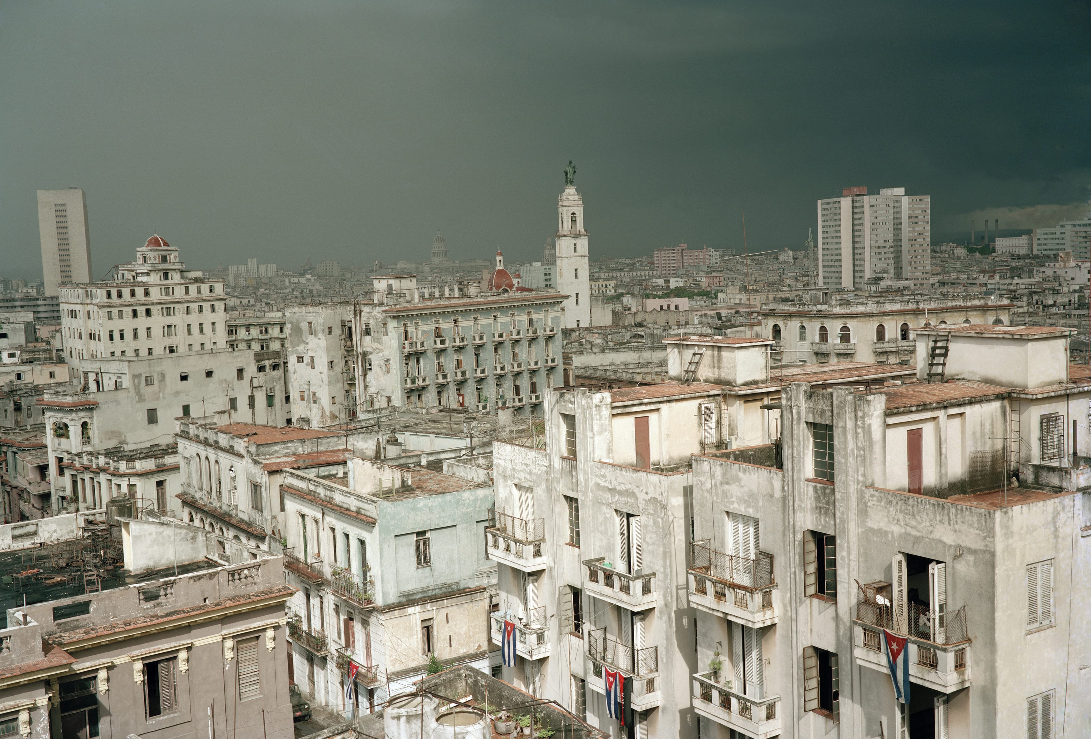 Flags are flown for the anniversary of the storming of the Moncada Barracks in Santiago de Cuba (1953). This event is considered the beginning of the Cuban Revolution. The view is from the Hotel Colina in Vedado looking towards Old Havana.