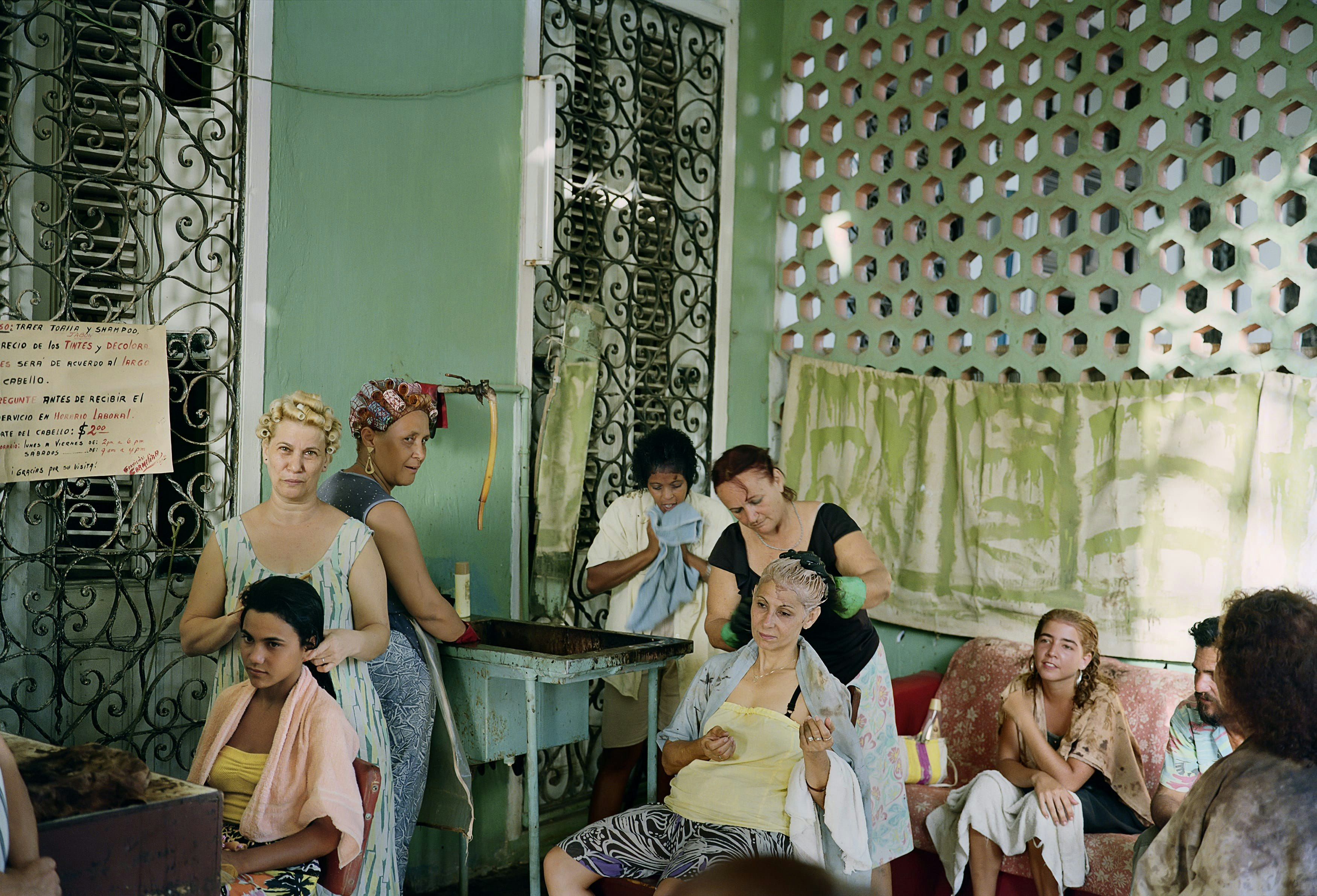 One of more widely published and sold images from the series, a beauty salon in the residential neighborhood of Vedado provides services on the back patio of a private home during the era of economic hardship known as “the Special Period.”