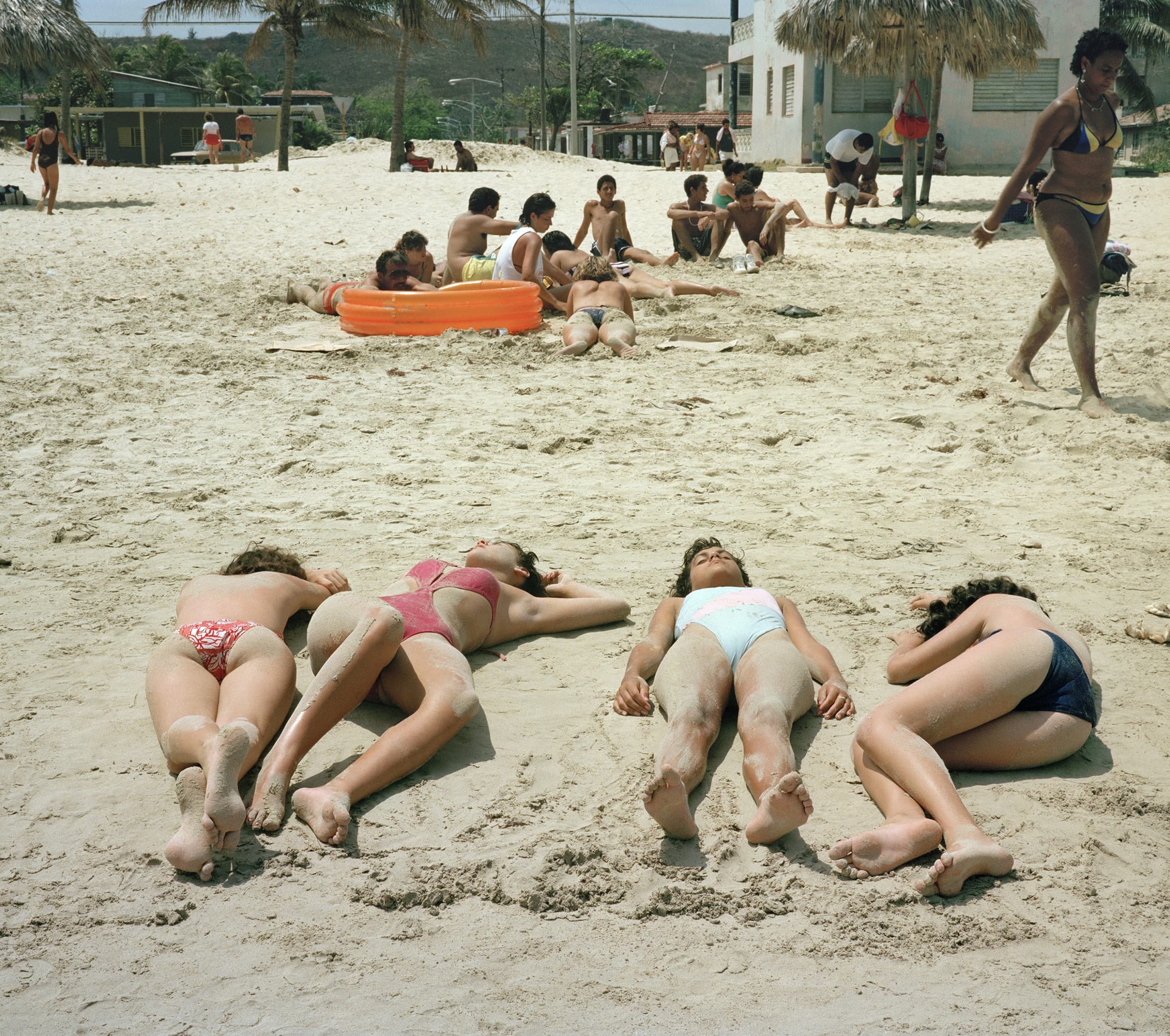 Family of 4 women laying down on a beach in Cuba