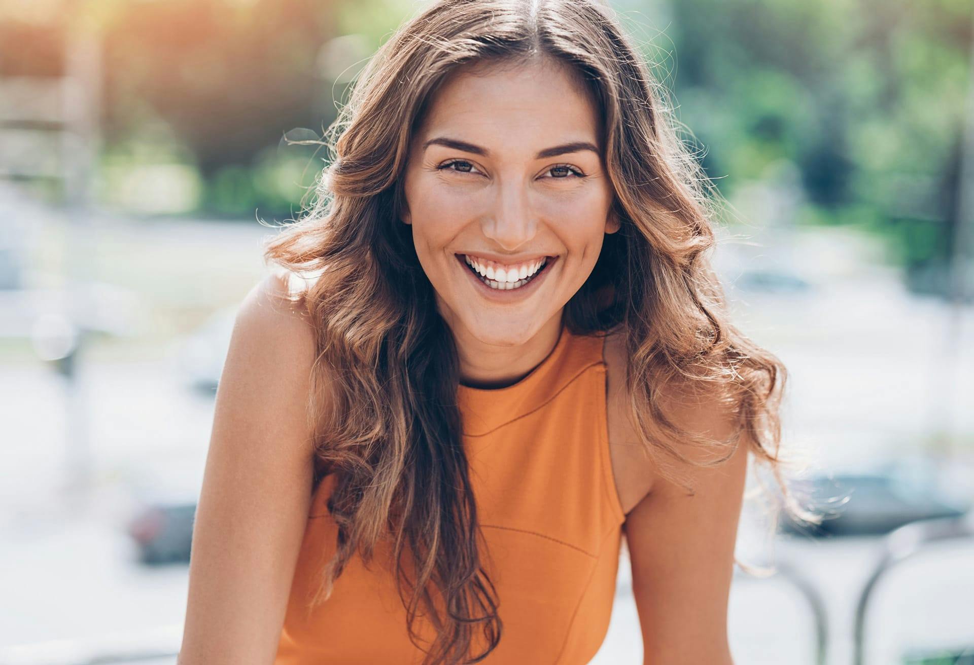 woman in orange smiling