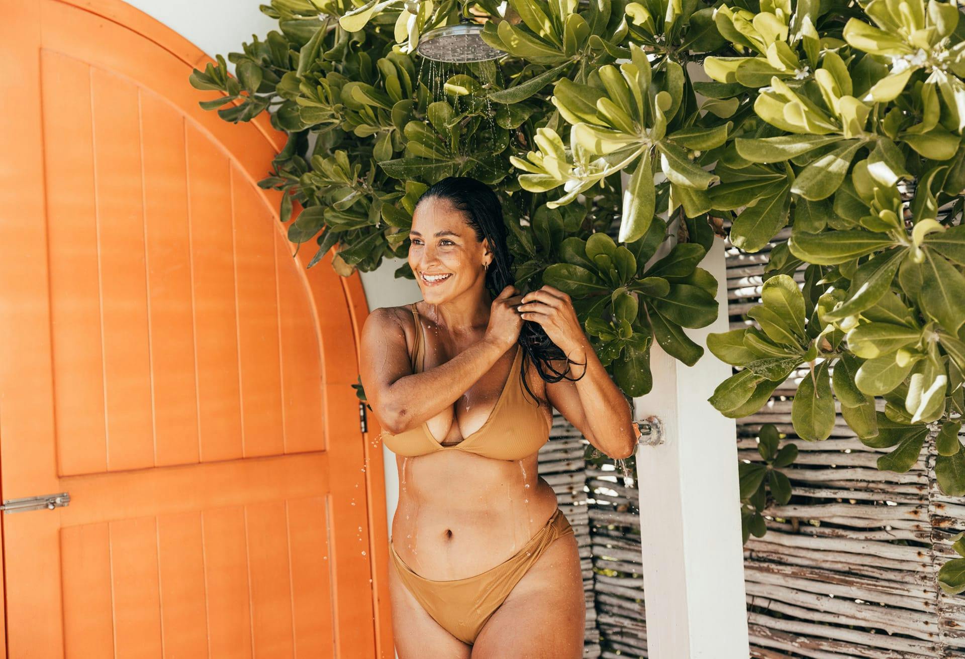 woman in brown bikini smiling