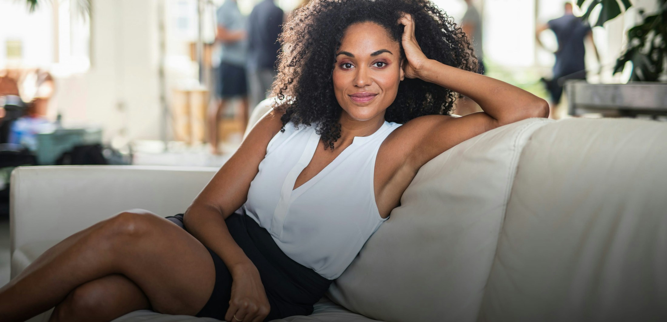 Happy woman posing on a couch.