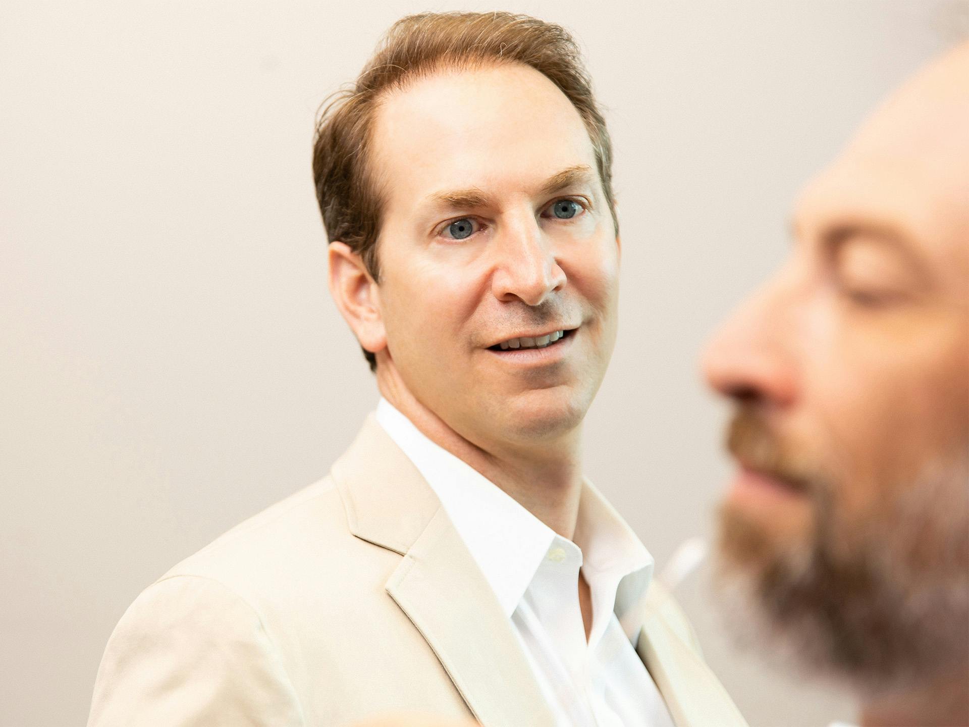 Doctor examining man's face during consultation
