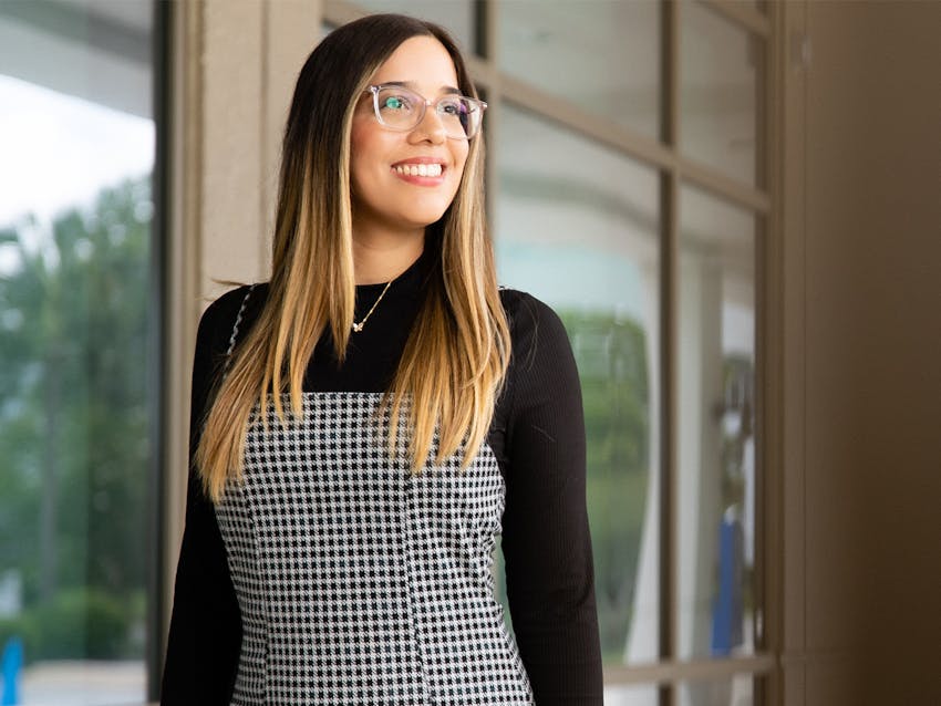 Woman wearing glasses and plaid dress