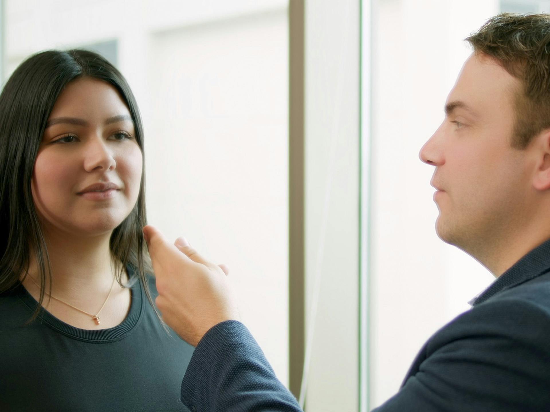 Black haired woman having a consultation with plastic surgeon