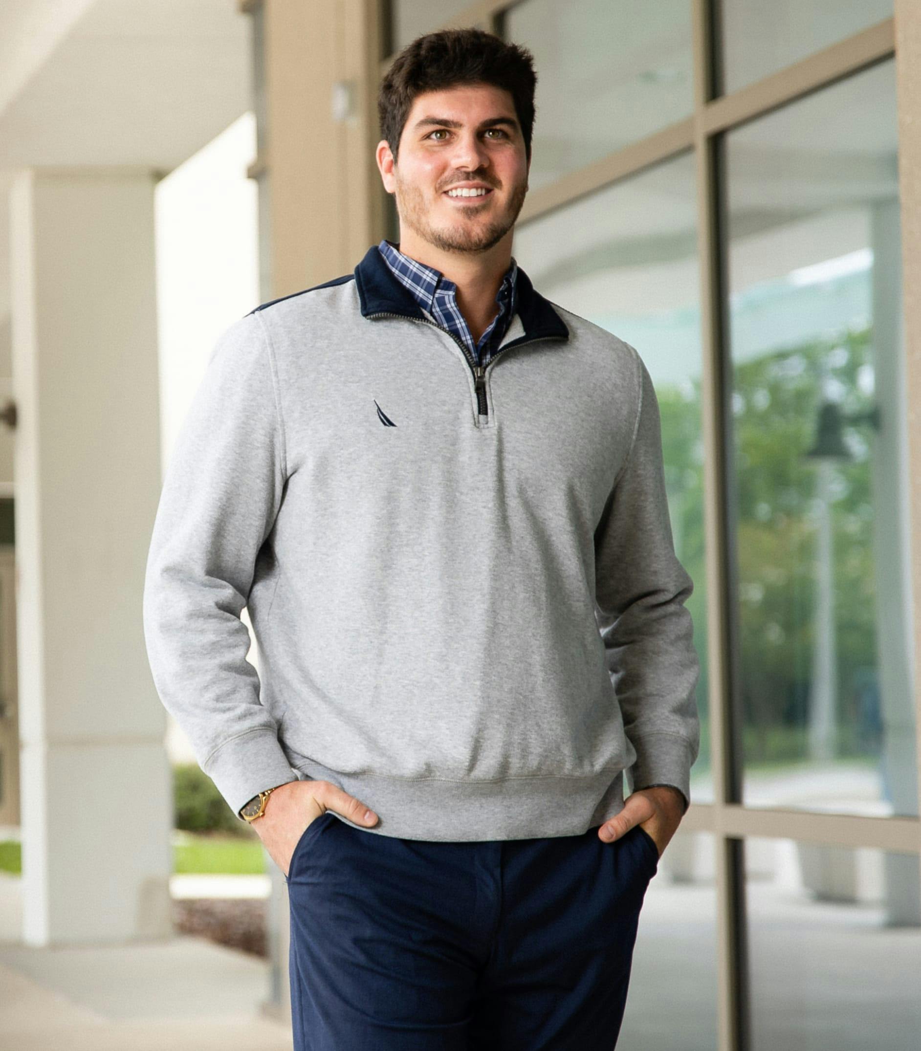 Man wearing trendy clothes and smiling.