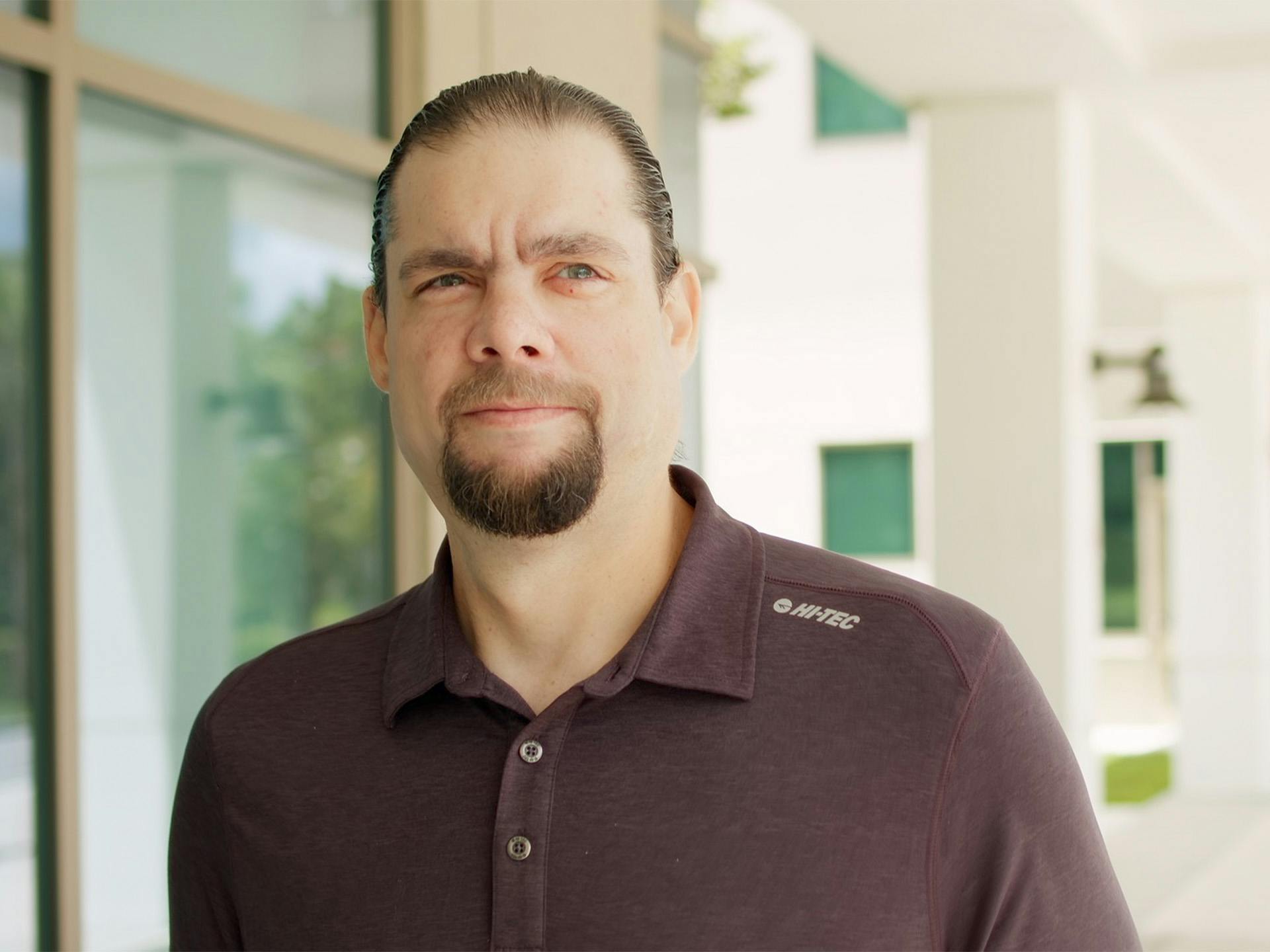 Man with facial hair standing outside
