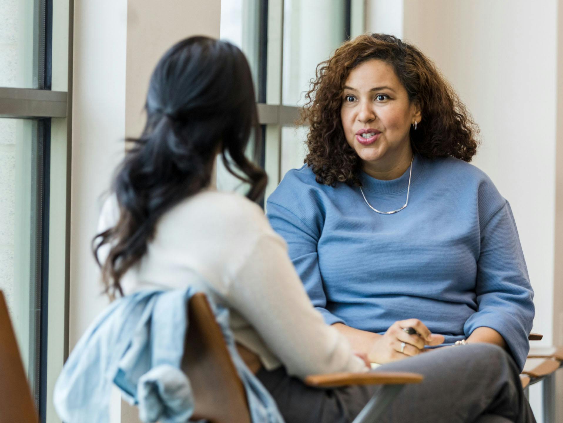 Two women speaking to each other