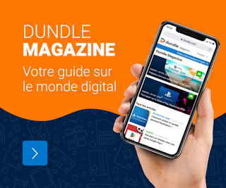 Une main tenant un téléphone portable s'est ouverte sur la page du magazine dundle sur fond orange et bleu.