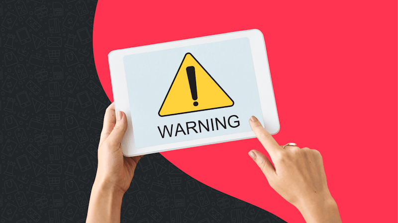 Alt text: A dundle red and black background with a white Ipad in the foreground showing a warning symbol