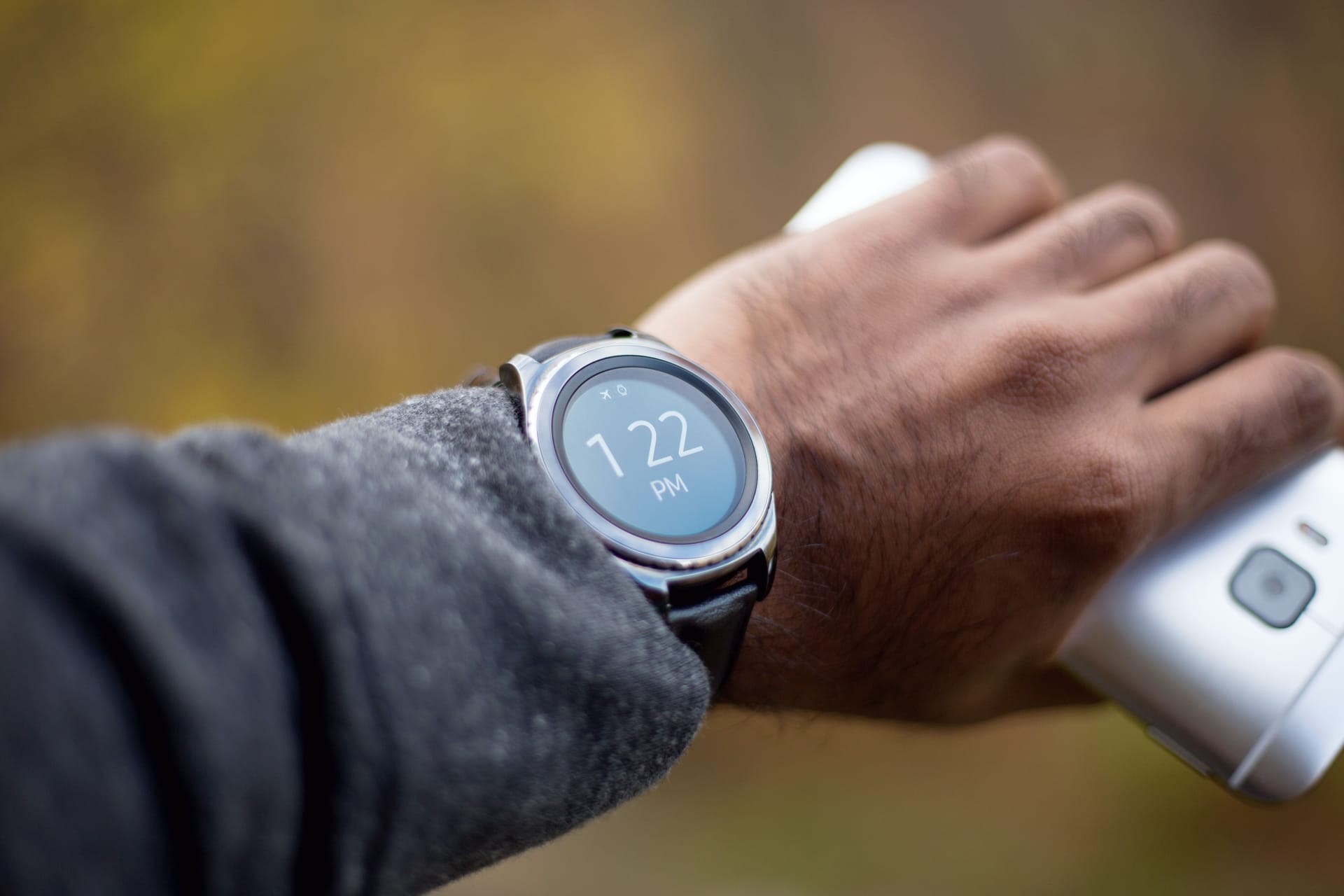 Man’s wrist with a smartwatch that shows the time