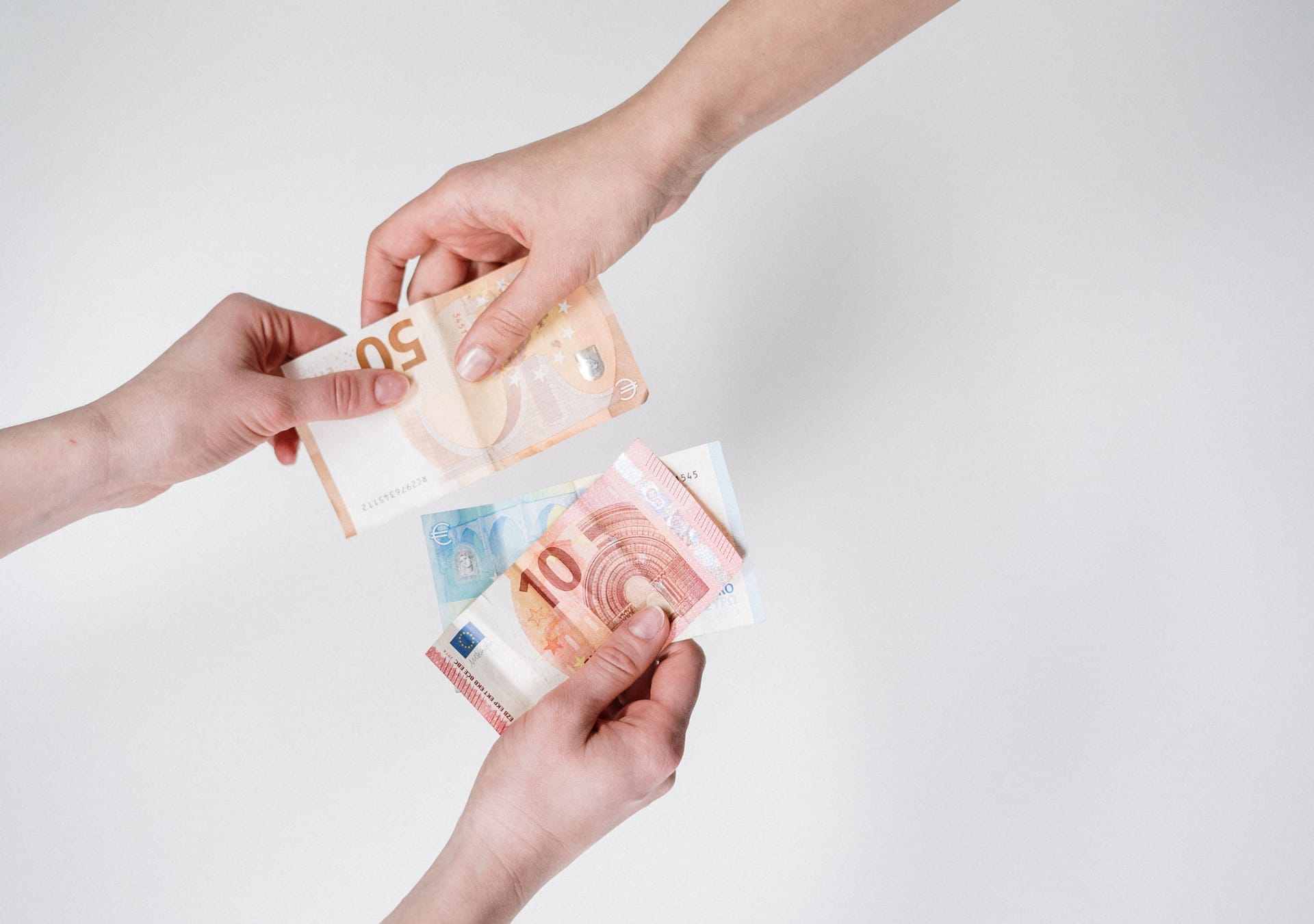 Hands exchanging foreign currency.