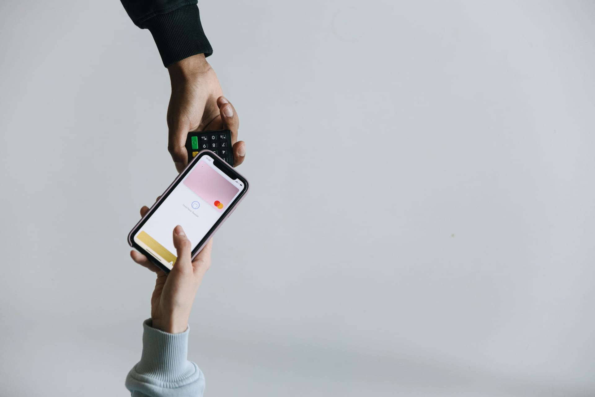Hands illustrating contactless mobile payment.