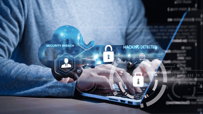 Articla banner image of a cibersecurity professional working on a laptop.