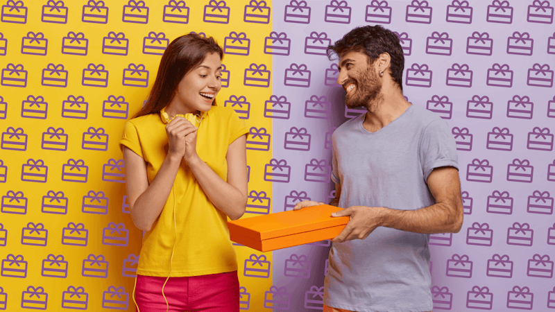 A man giving a gift to a woman and they are both happy
