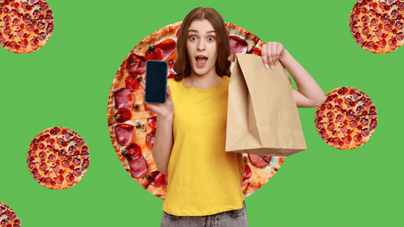 A girl with an excited face holding a paper bag in one hand and a smartphone in the other on a pizza background.