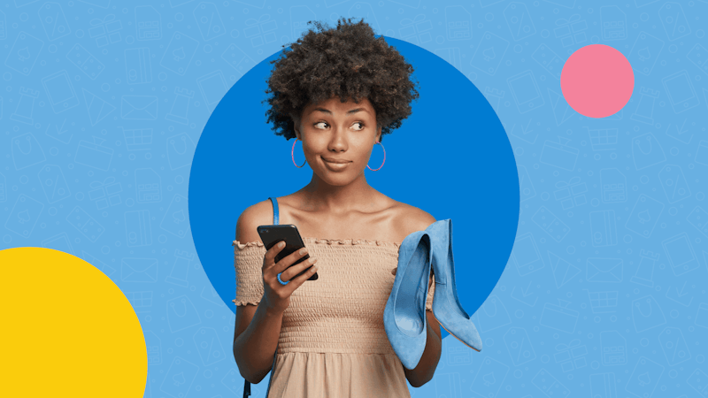 Woman holding shoes and a phone