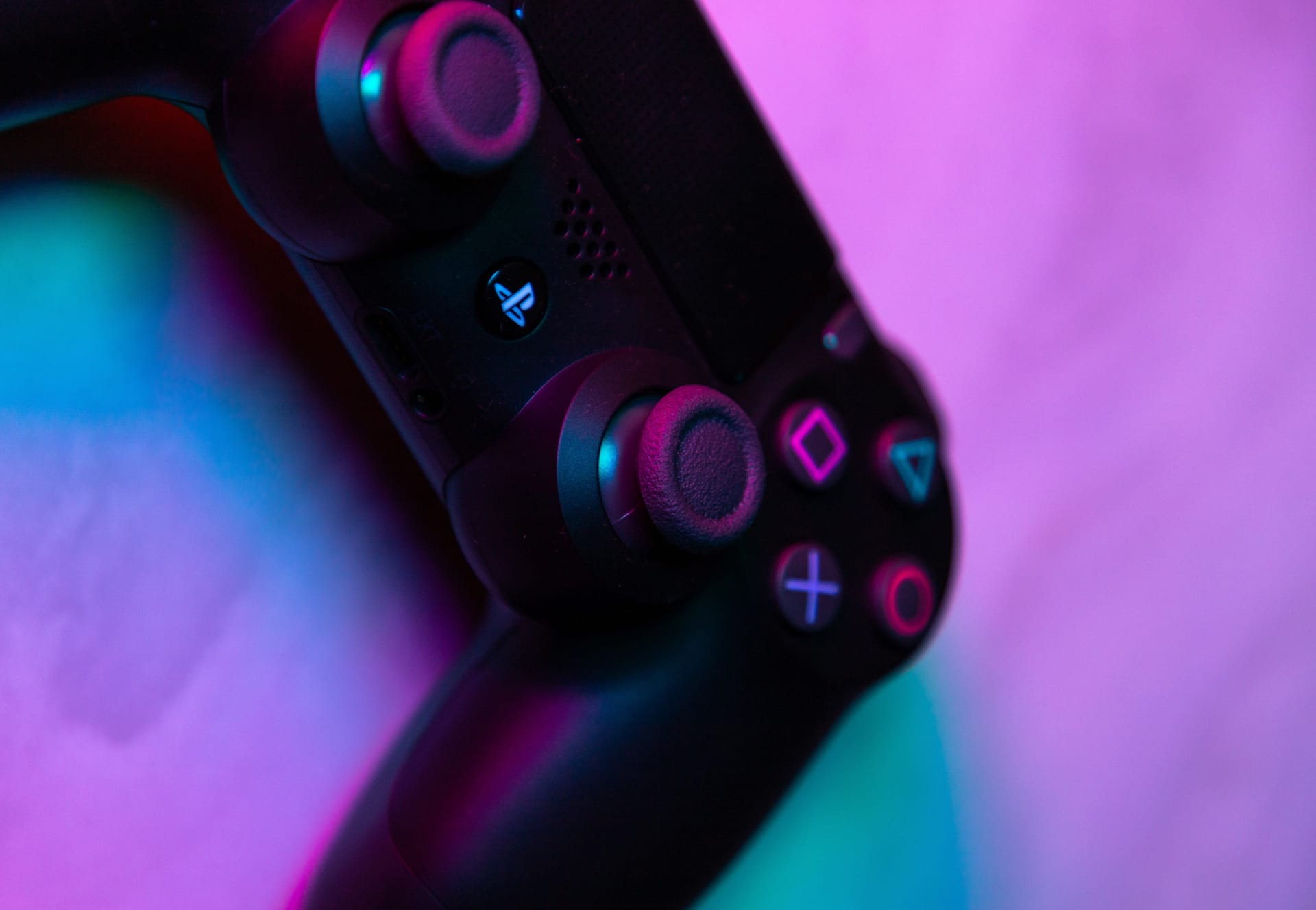 PlayStation controller against a blue/purple background.