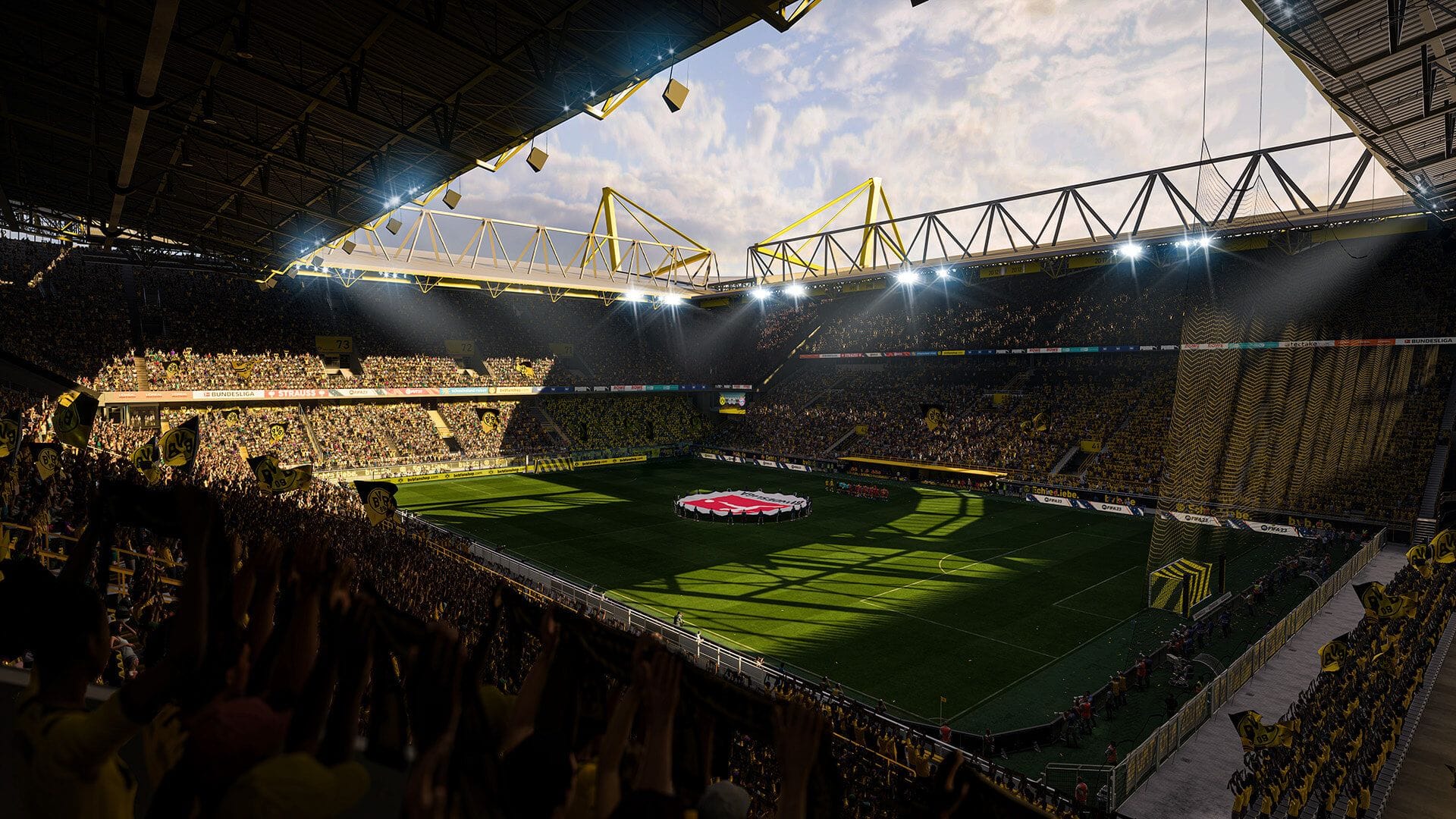 A huge football stadium full of people, lights aimed on the field, and clouds in the sky in FIFA 23.