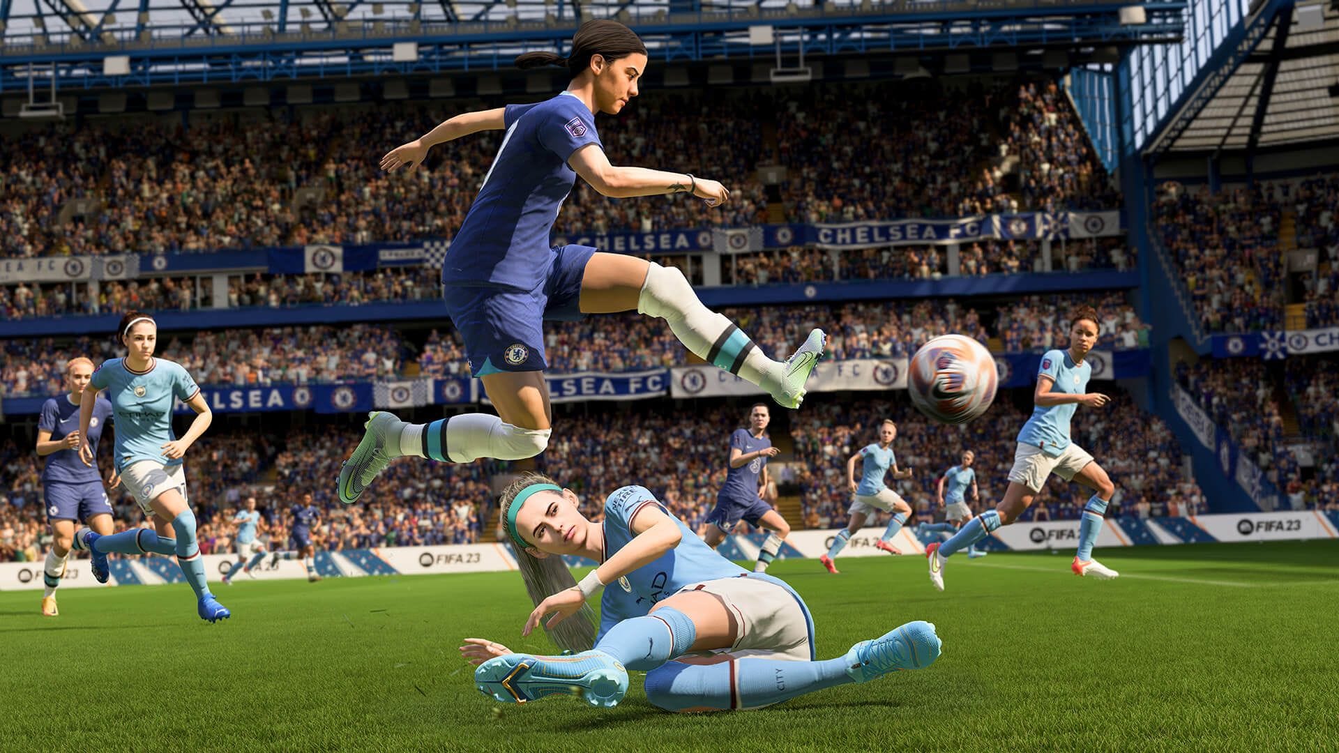 A female football player in FIFA 23 jumping with the ball over a sliding football player. Other players running around in the stadium full of people.