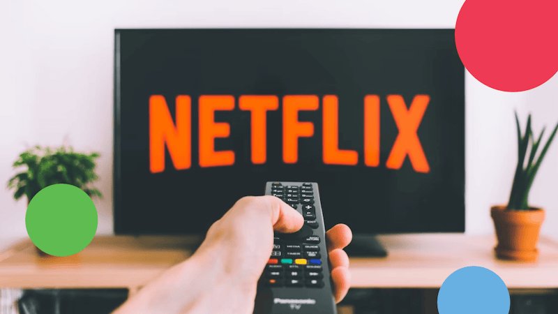 a person holding a pilot in font of a screen with Netflix logo