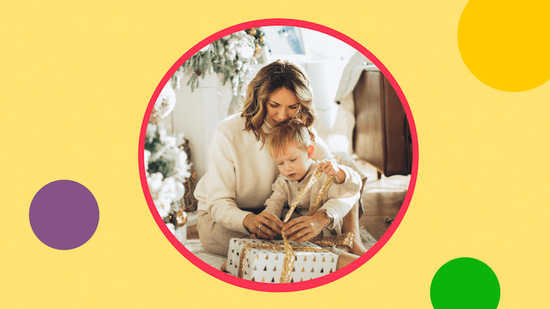 Mother with a small child opening a Christmas present