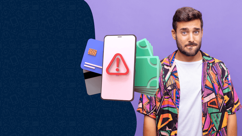 A man in a colorful shirt with a questionable look on his face. In front of him, there is a phone with a warning screen and several credit cards.