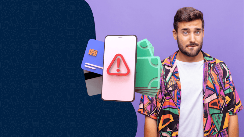 A man in a colorful shirt with a questionable look on his face. In front of him, there is a phone with a warning screen and several credit cards.